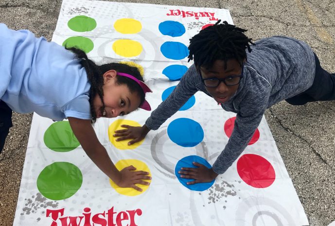 two students playing twister