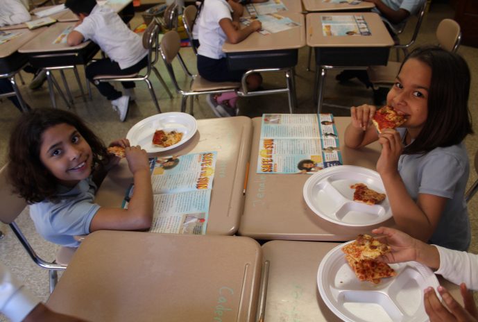 2 Second grade girls eating pizza